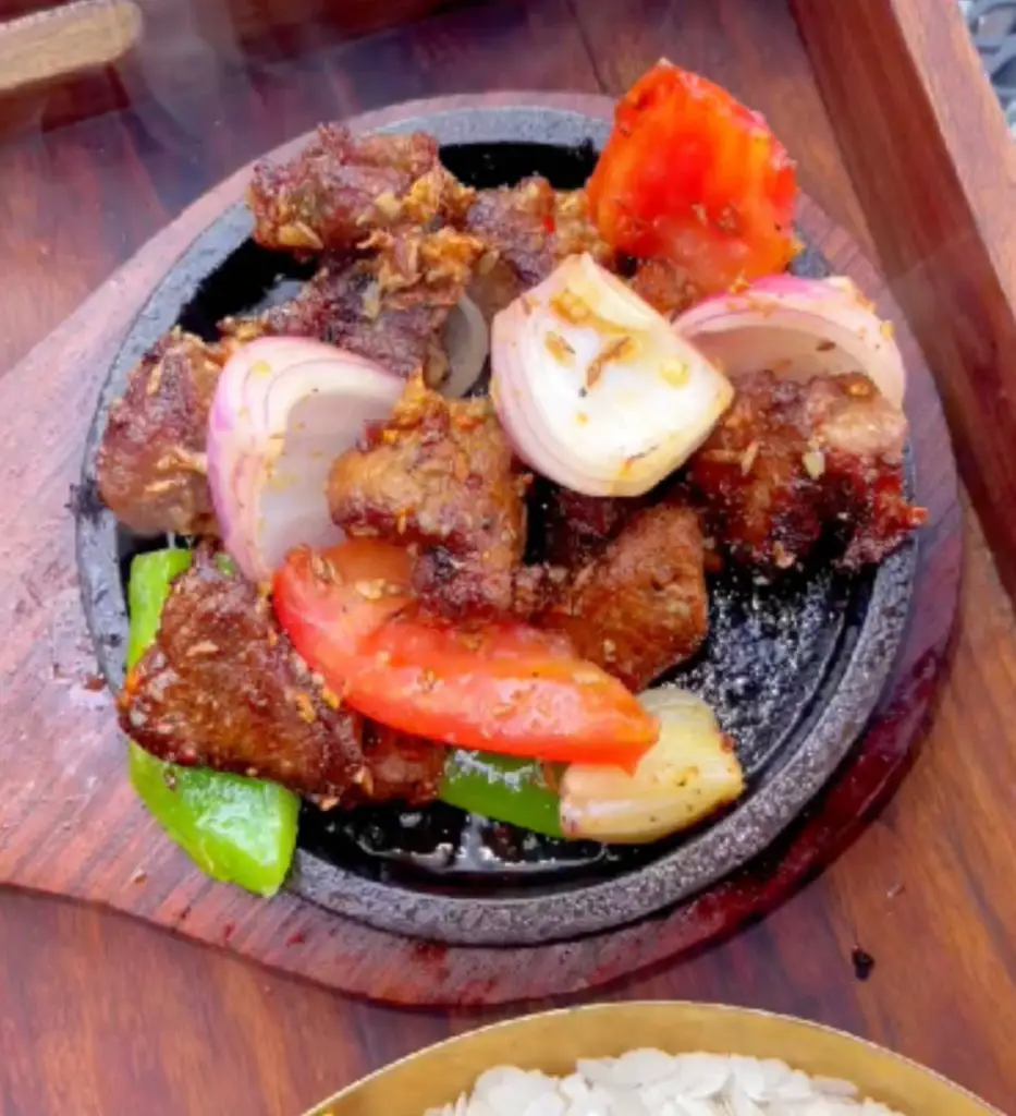 Grilled meat served up on a griddle at Bajeko Sekuwa.