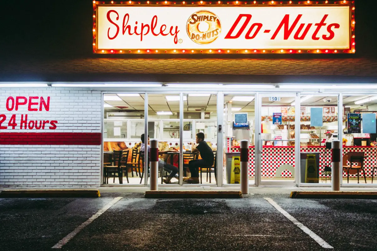 The exterior of a Shipley Do-Nuts 24 hour diner.